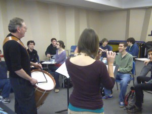 Bill on the left and Magan on fife, with the studio class listening to "Peas Upon a Trencher" and having fun with the concept of using a wooden dinner plate as a trench shovel.