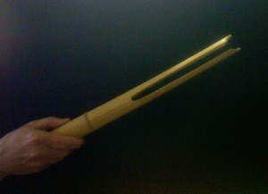 A "devil chaser" (split bamboo) used as one of the two "Cricket Callers" in John Cage's "Third Construction"