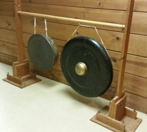 Photo 9 - Gongs suspended from screw hooks on a home-made wooden rack